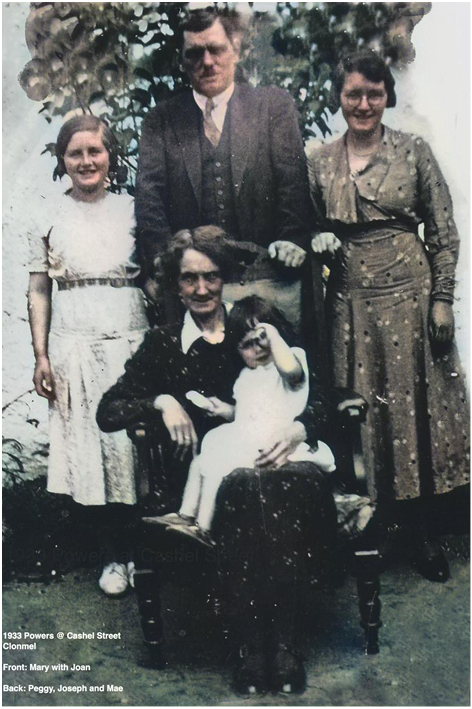 Joan in her Mother's lap, with her Father standing and her sisters Peggy {L} and May {R}. Taken at 50 Cashel Road before the Family moved to St. Patrick’s Terrace.